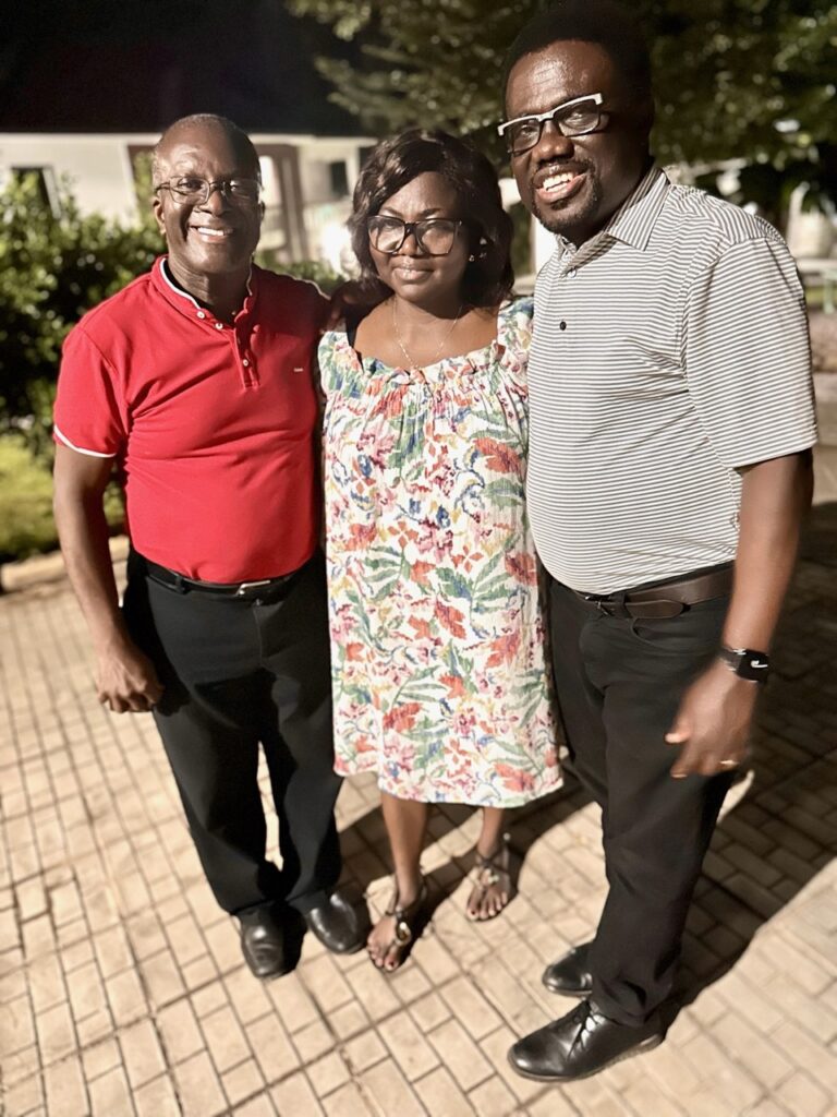 two smiling men and a woman